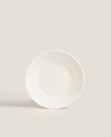 Earthenware side plate with raised-design edge